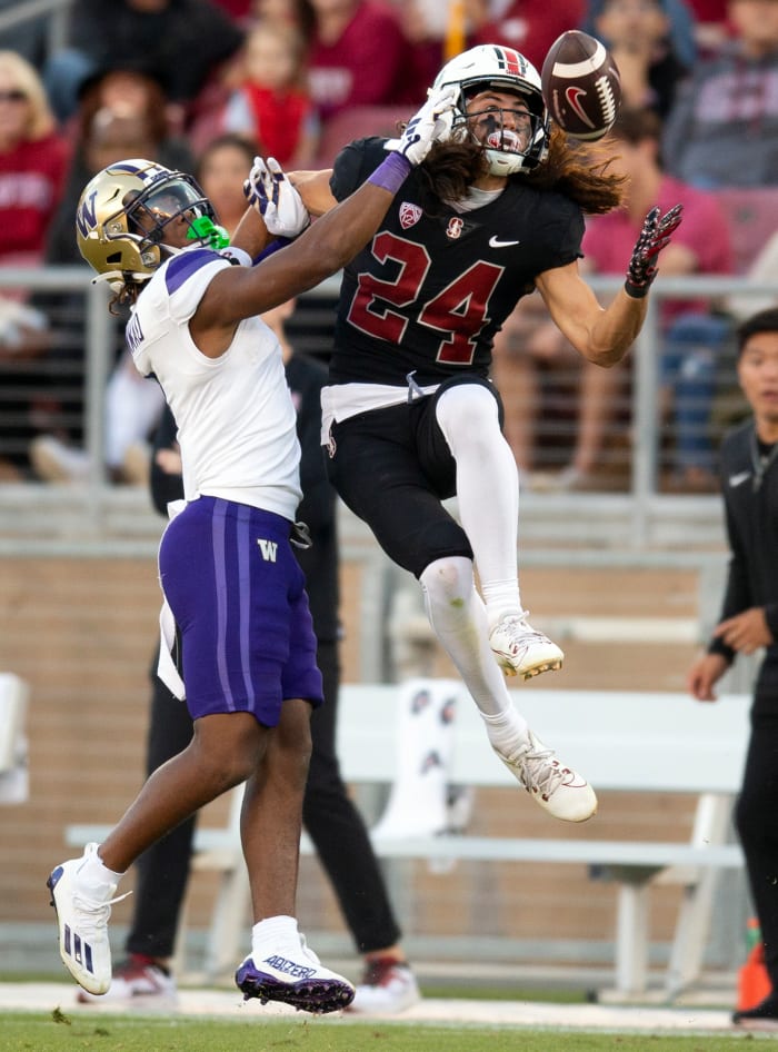 Oct 28, 2023; Stanford, California, USA; Stanford Cardinal wide receiver Tiger Bachmeier (24) leaps to make the catch of a pass in front of Washington Huskies cornerback Jabbar Muhammad (1) during the second quarter at Stanford Stadium. Mandatory Credit: D. Ross Cameron-USA TODAY Sports